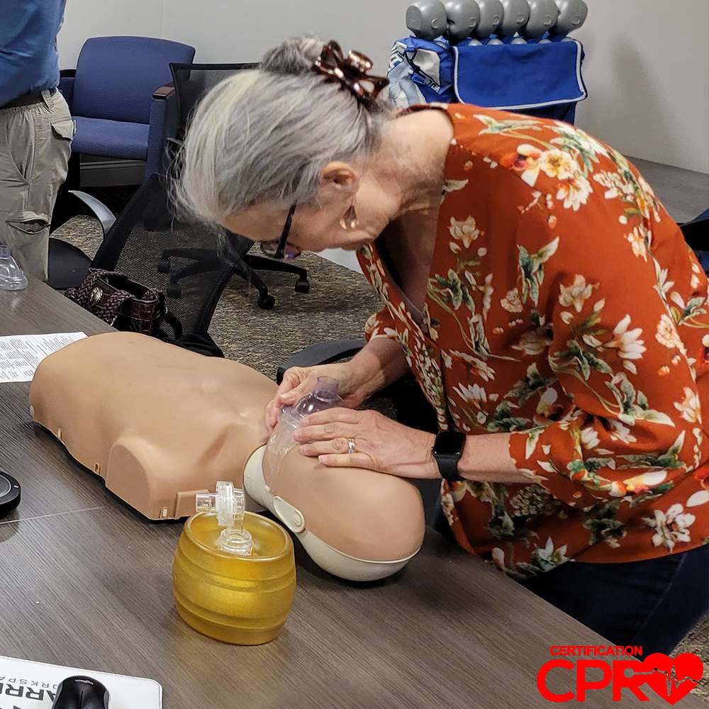 CPR training session with adult mannequin in Boston.