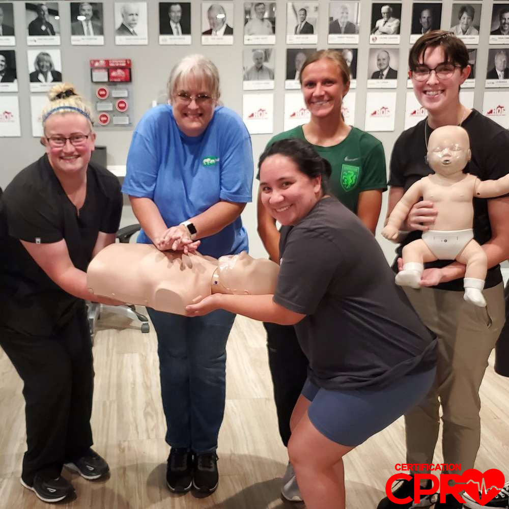 CPR training class in Boston with students practicing on mannequins.