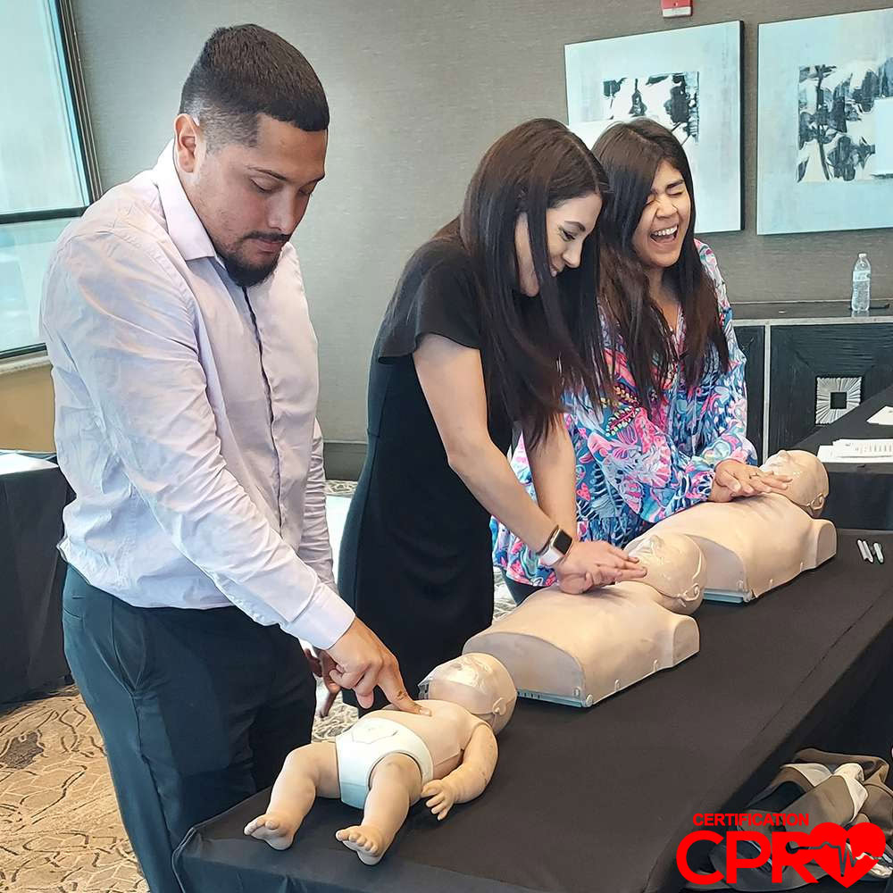 CPR training class in Boston with students practicing on mannequins.